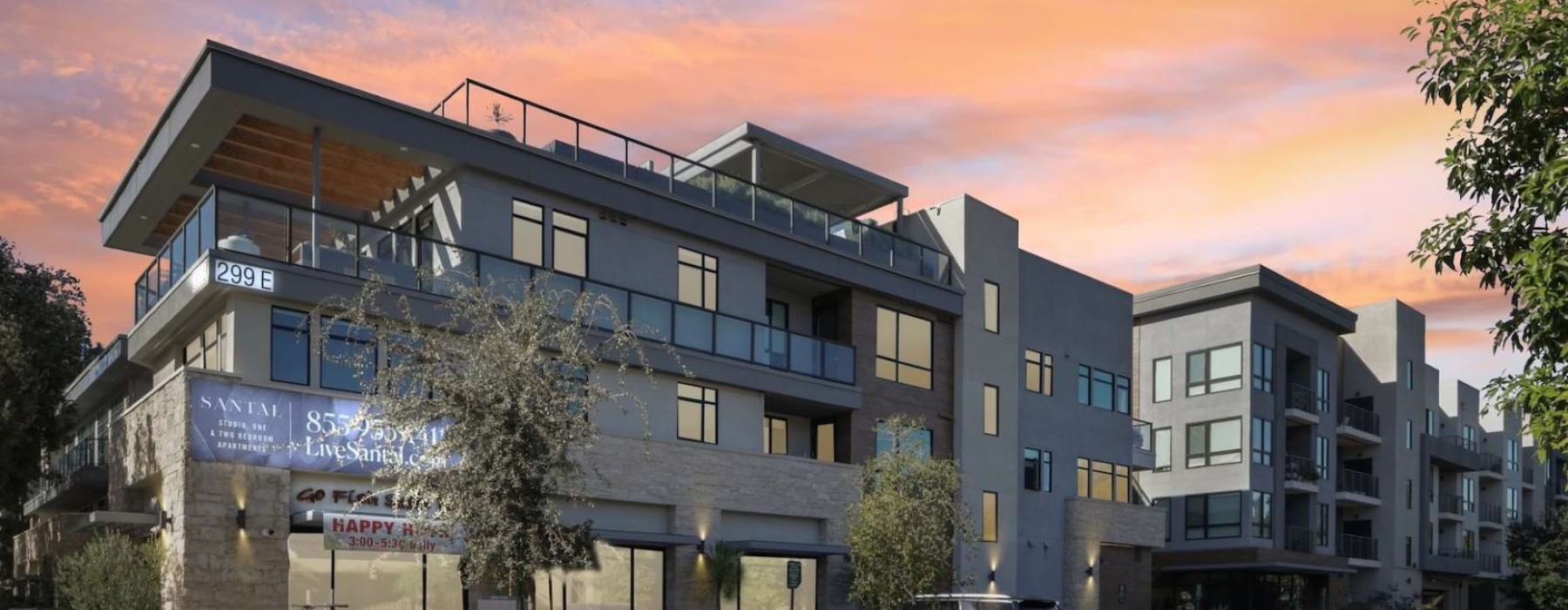 A sunset exterior shows modern balconies, street-level retail, and LiveSantal.com signage on the Santal Thousand Oaks building.