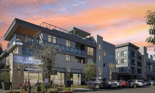 A sunset exterior shows modern balconies, street-level retail, and LiveSantal.com signage on the Santal Thousand Oaks building.